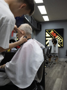 student practicing a mens haircut.