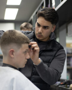 student practicing a mens haircut